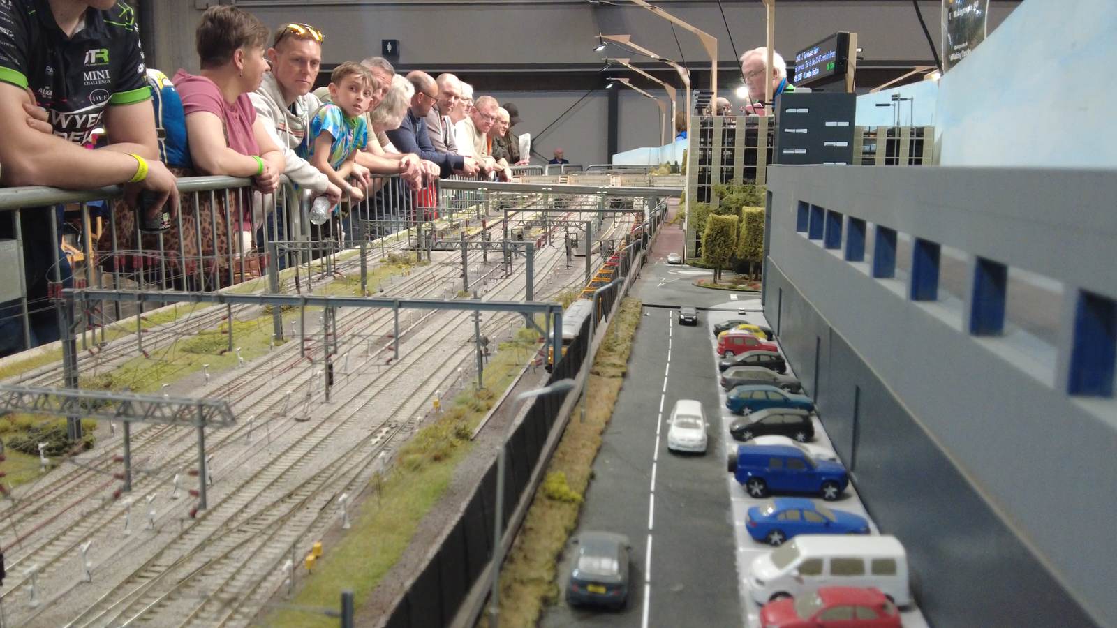Visitors leaning over the barrier watching trains run on the Making Tracks layout